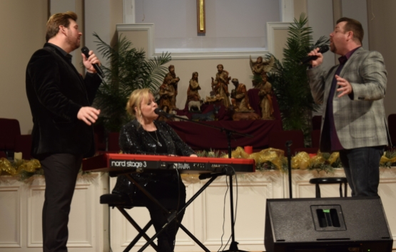 Jim and Melissa Brady and Steve Ladd sing "Through It All" near the end of the annual New Year's Eve concert at Sand Spring Baptist Church.